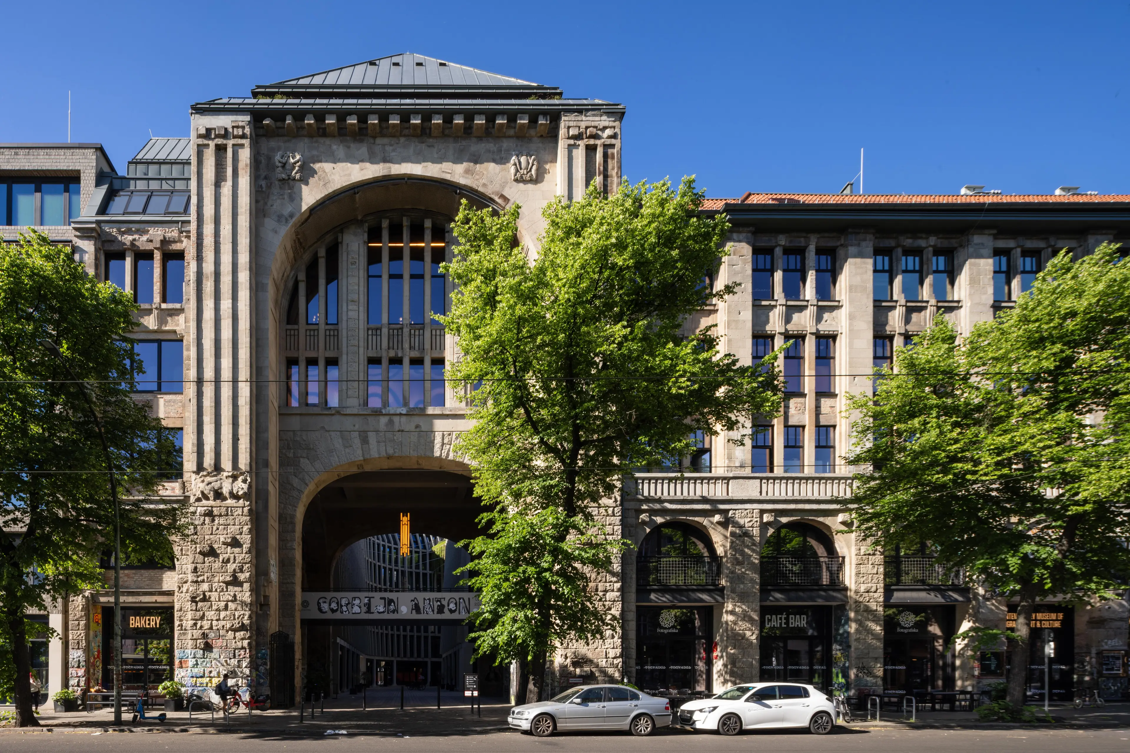 Image of an historic building with many windows and people.